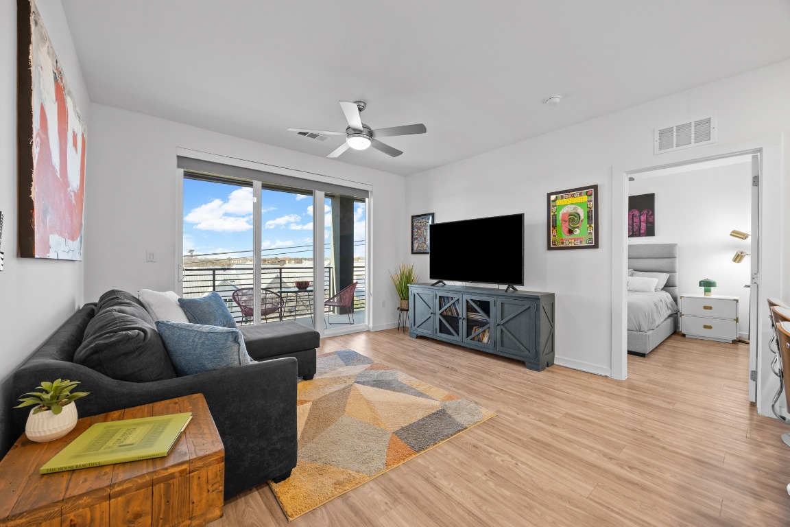 4801 Springdale Road, Unit 1401 Austin, TX 78723 - Photo 1 of 40 a living room with furniture a flat screen tv and a large window