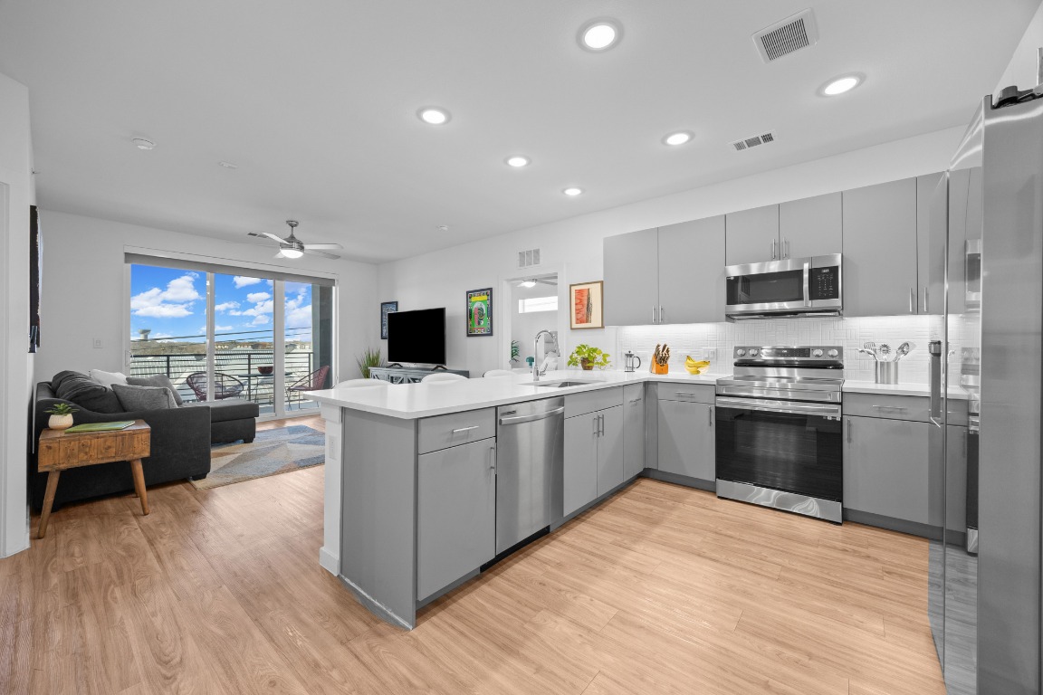 4801 Springdale Road, Unit 1401 Austin, TX 78723 - Photo 13 of 40 a kitchen with a sink cabinets and stainless steel appliances