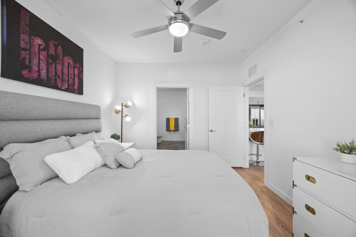 4801 Springdale Road, Unit 1401 Austin, TX 78723 - Photo 19 of 40 a bedroom with a bed and a chandelier