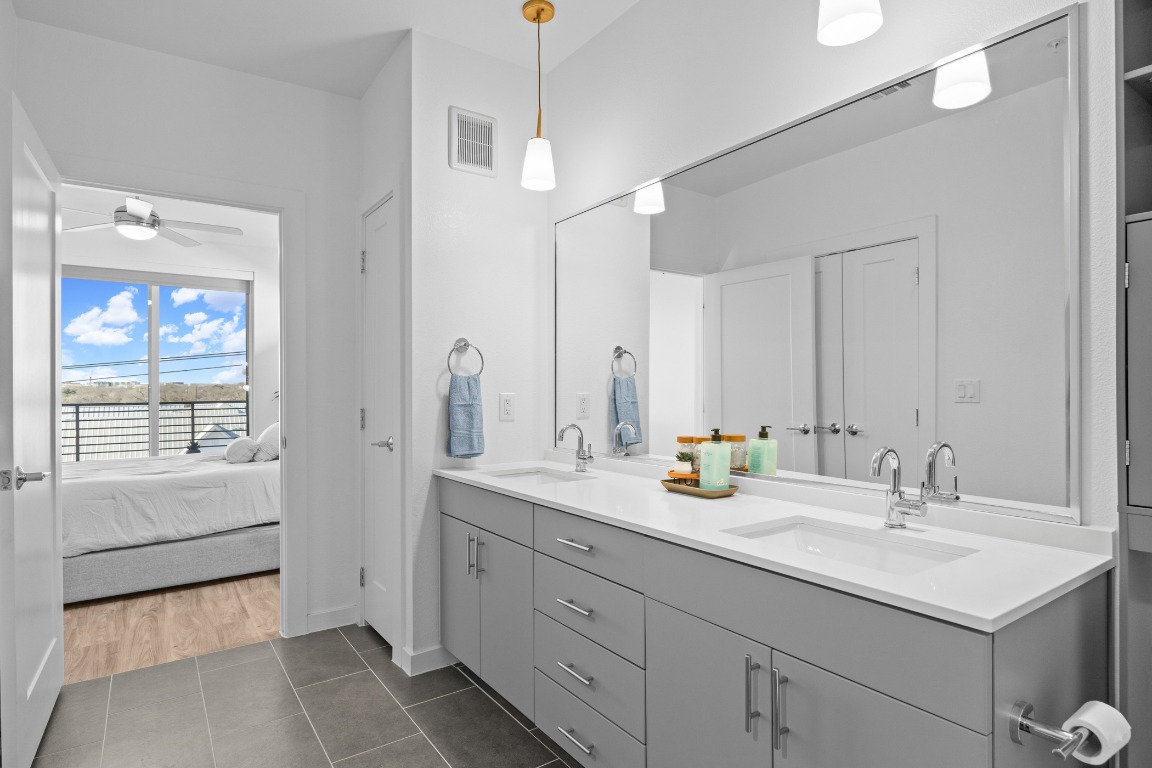 4801 Springdale Road, Unit 1401 Austin, TX 78723 - Photo 21 of 40 a bathroom with a sink double vanity and a mirror