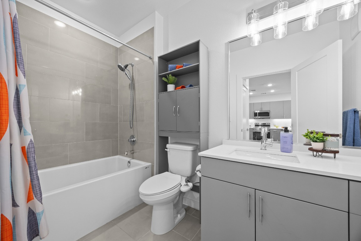 4801 Springdale Road, Unit 1401 Austin, TX 78723 - Photo 23 of 40 a bathroom with a sink a toilet and shower