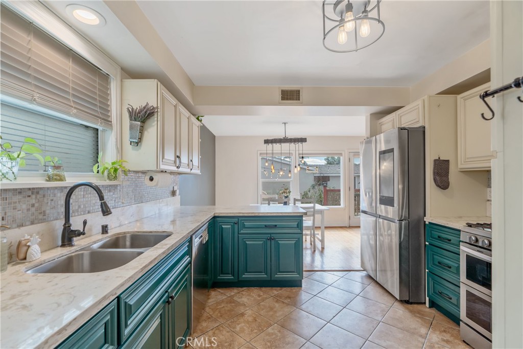 a kitchen with a sink refrigerator and cabinets