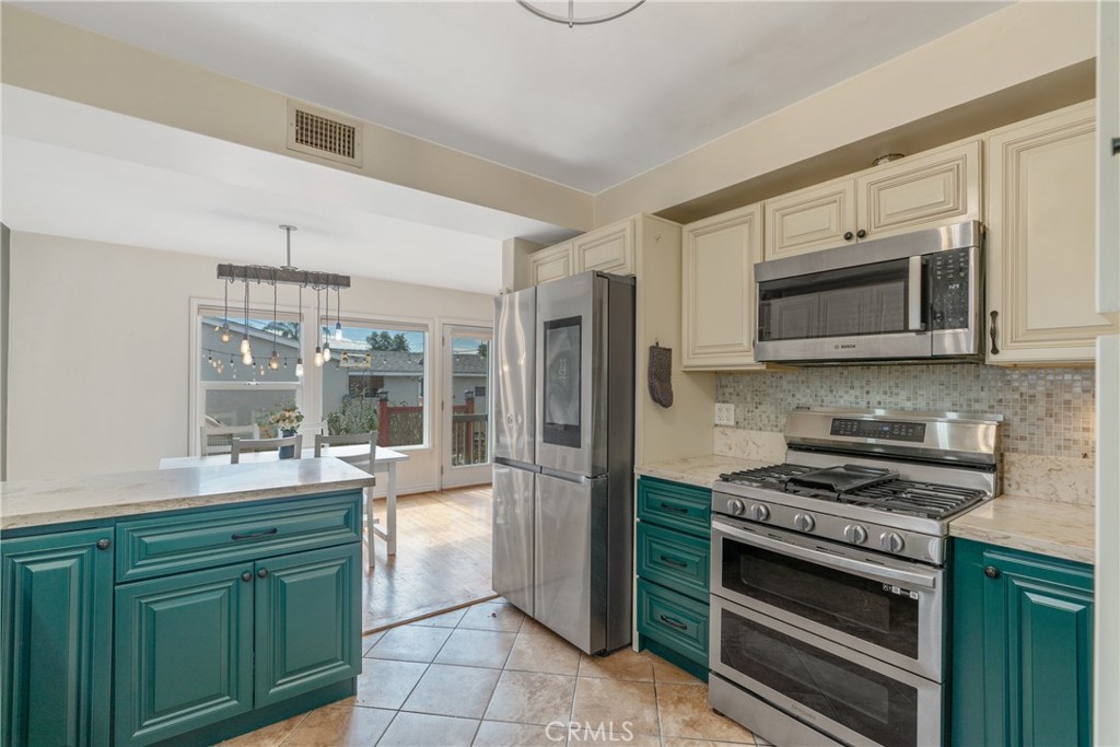 14844 Lull Street Van Nuys, CA 91405 - Photo 12 of 31 a kitchen with stainless steel appliances a stove a sink and a microwave
