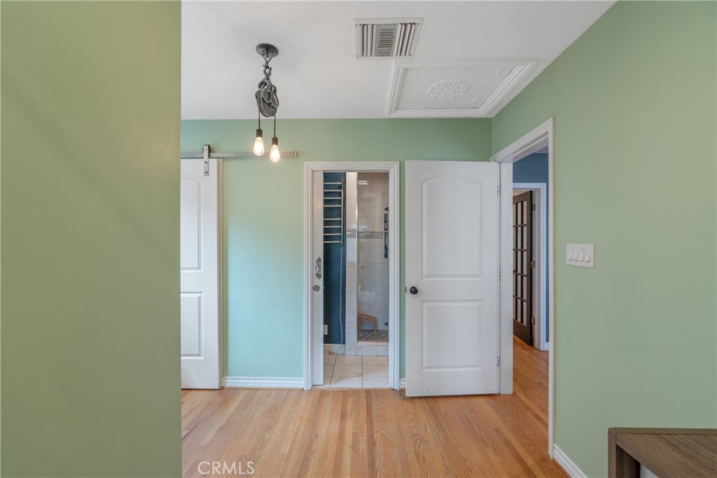 14844 Lull Street Van Nuys, CA 91405 - Photo 15 of 31 a view of a hallway with wooden floor and staircase