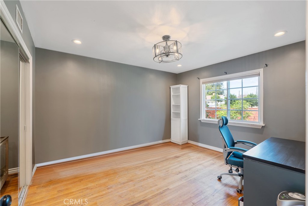 14844 Lull Street Van Nuys, CA 91405 - Photo 17 of 31 a view of a livingroom with a window and wooden floor