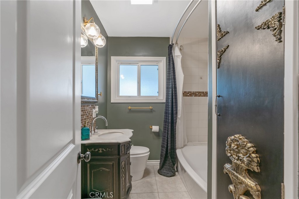 14844 Lull Street Van Nuys, CA 91405 - Photo 18 of 31 a bathroom with a sink toilet and shower