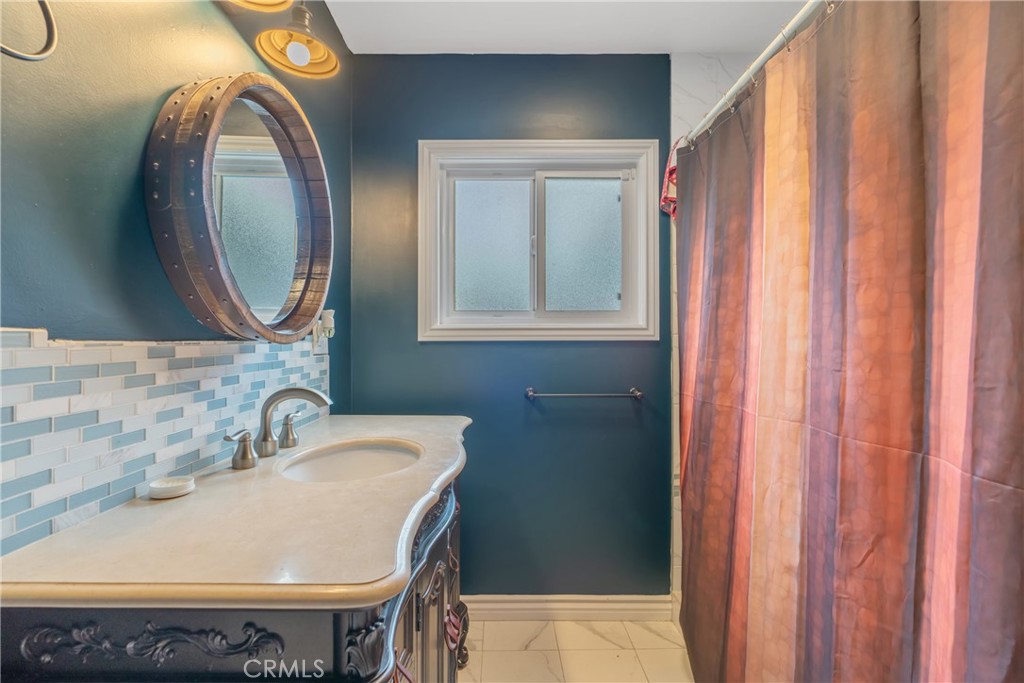 14844 Lull Street Van Nuys, CA 91405 - Photo 23 of 31 a bathroom with a sink and a mirror