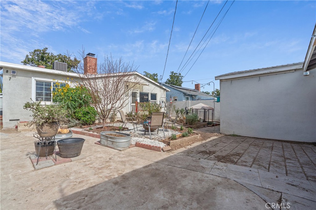 14844 Lull Street Van Nuys, CA 91405 - Photo 26 of 31 a view of a patio with table and chairs potted plants