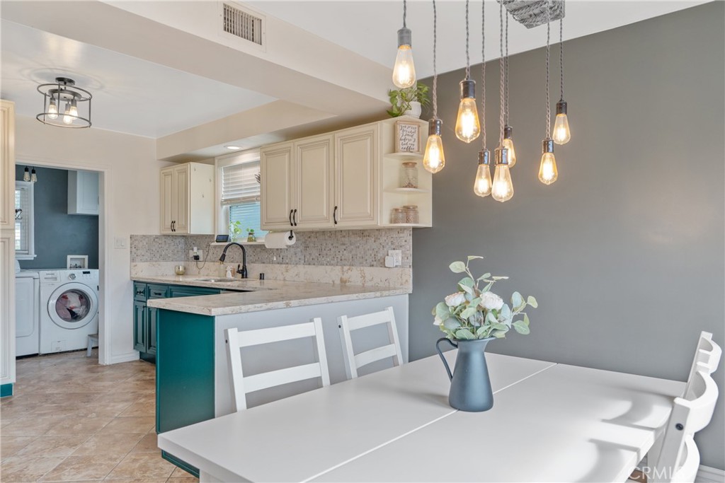 14844 Lull Street Van Nuys, CA 91405 - Photo 8 of 31 a kitchen with a sink and cabinets