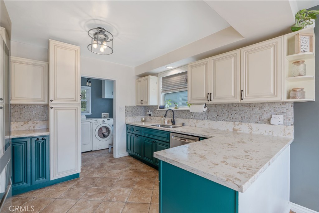14844 Lull Street Van Nuys, CA 91405 - Photo 10 of 31 a kitchen with a sink stove and refrigerator