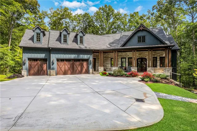 a view of house with a yard and sitting area