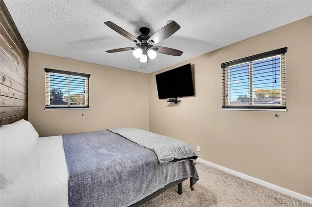 a bedroom with a large bed and a flat screen tv
