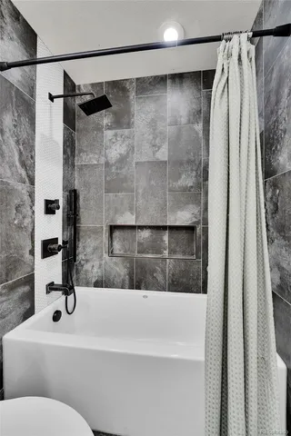 a bathroom with a bathtub and a shower