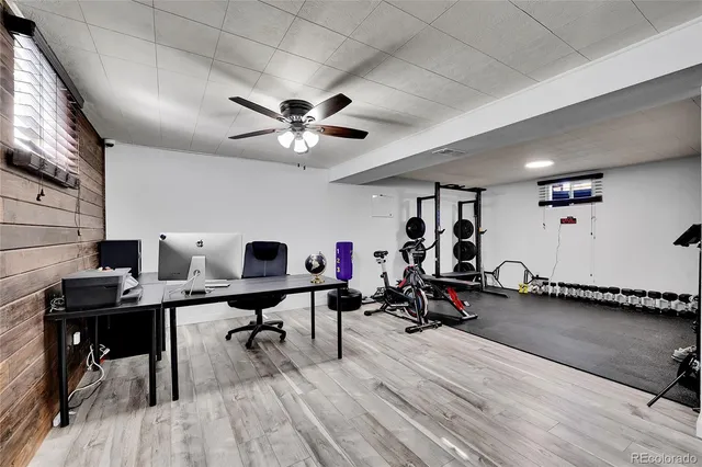 a view of a workspace with furniture and wooden floor