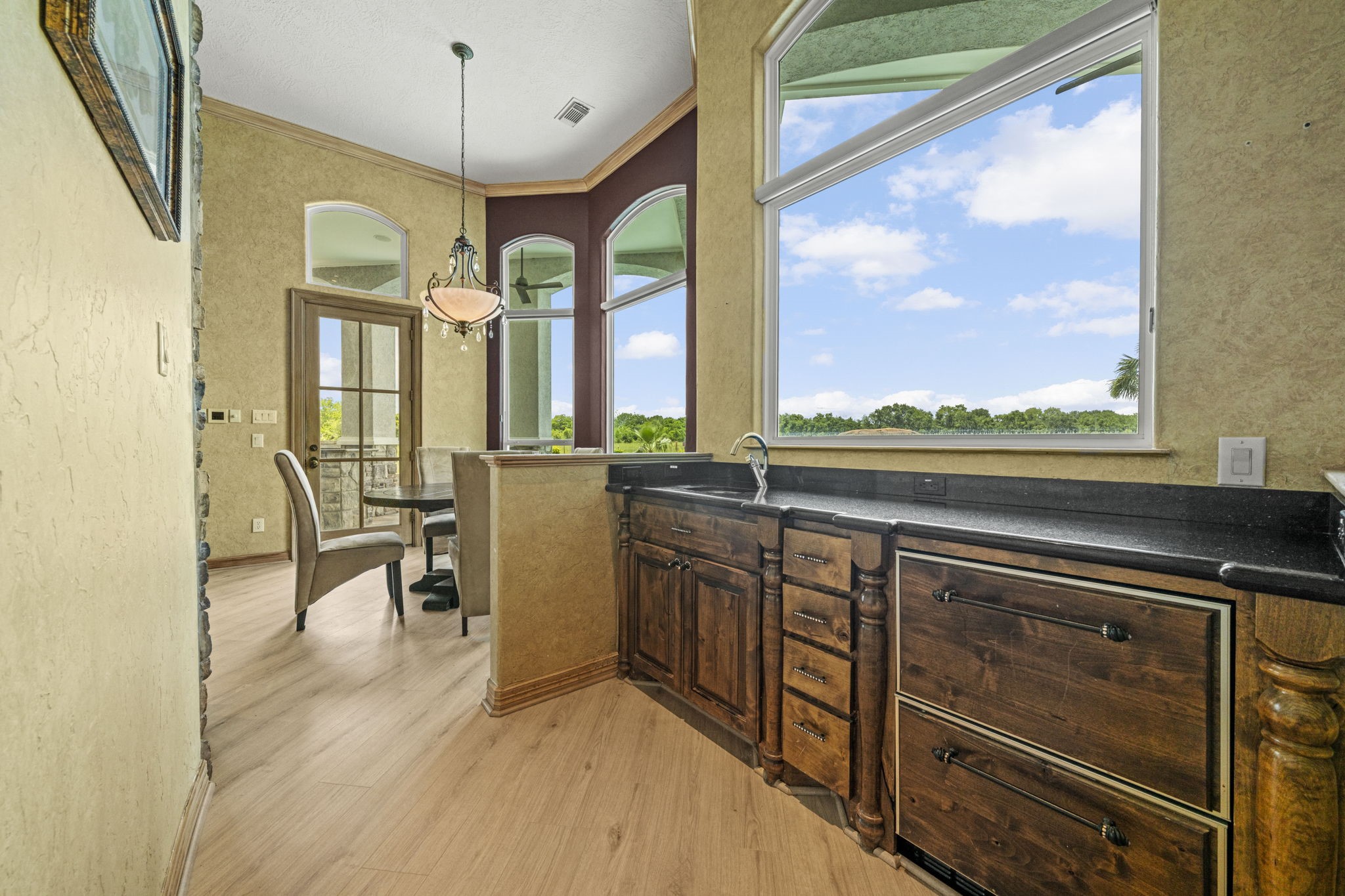 18732 Kz Road Cypress, TX 77433 - Photo 16 of 49 Thoughtfully designed for ultimate flow, featuring a bonus third sink and prep area that connects the kitchen directly to the breakfast bar.