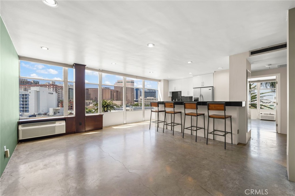 a view of dining room with furniture and floor to ceiling window