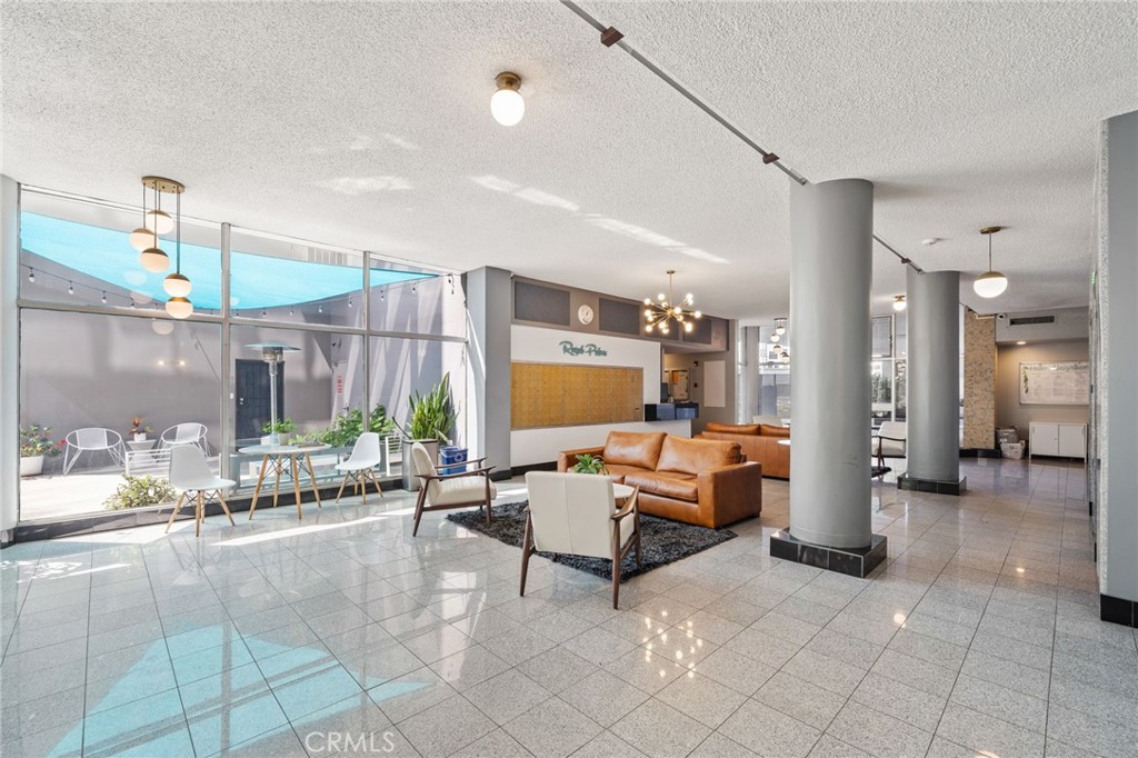 100 Atlantic Avenue, Unit 604 Long Beach, CA 90802 - Photo 21 of 29 a living room with furniture and a chandelier