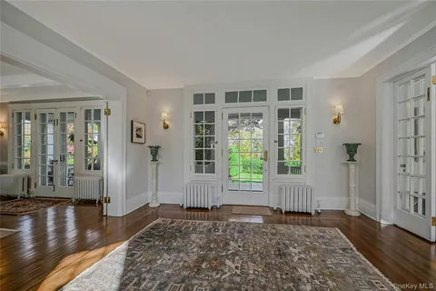 a view of a room with wooden floor and a window