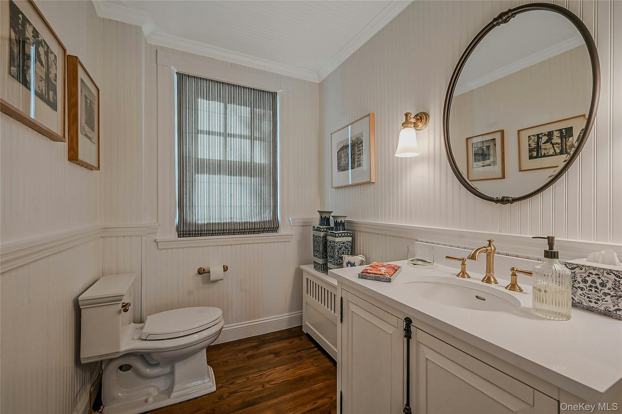 24 Harbor Hill Road Huntington Bay, NY 11743 - Photo 20 of 46 a bathroom with a toilet a sink and a mirror