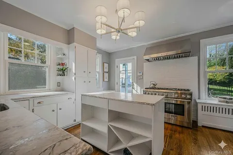 a kitchen with a stove a sink and a window