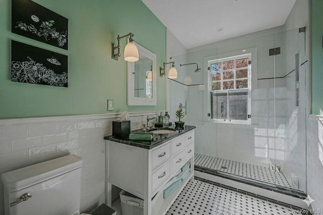 a bathroom with a sink toilet and shower