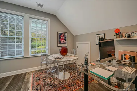 a work room with furniture and a window