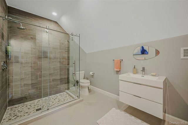 a bathroom with a sink mirror and a shower