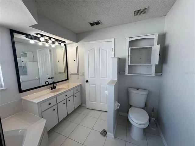 a bathroom with a double vanity sink mirror and toilet