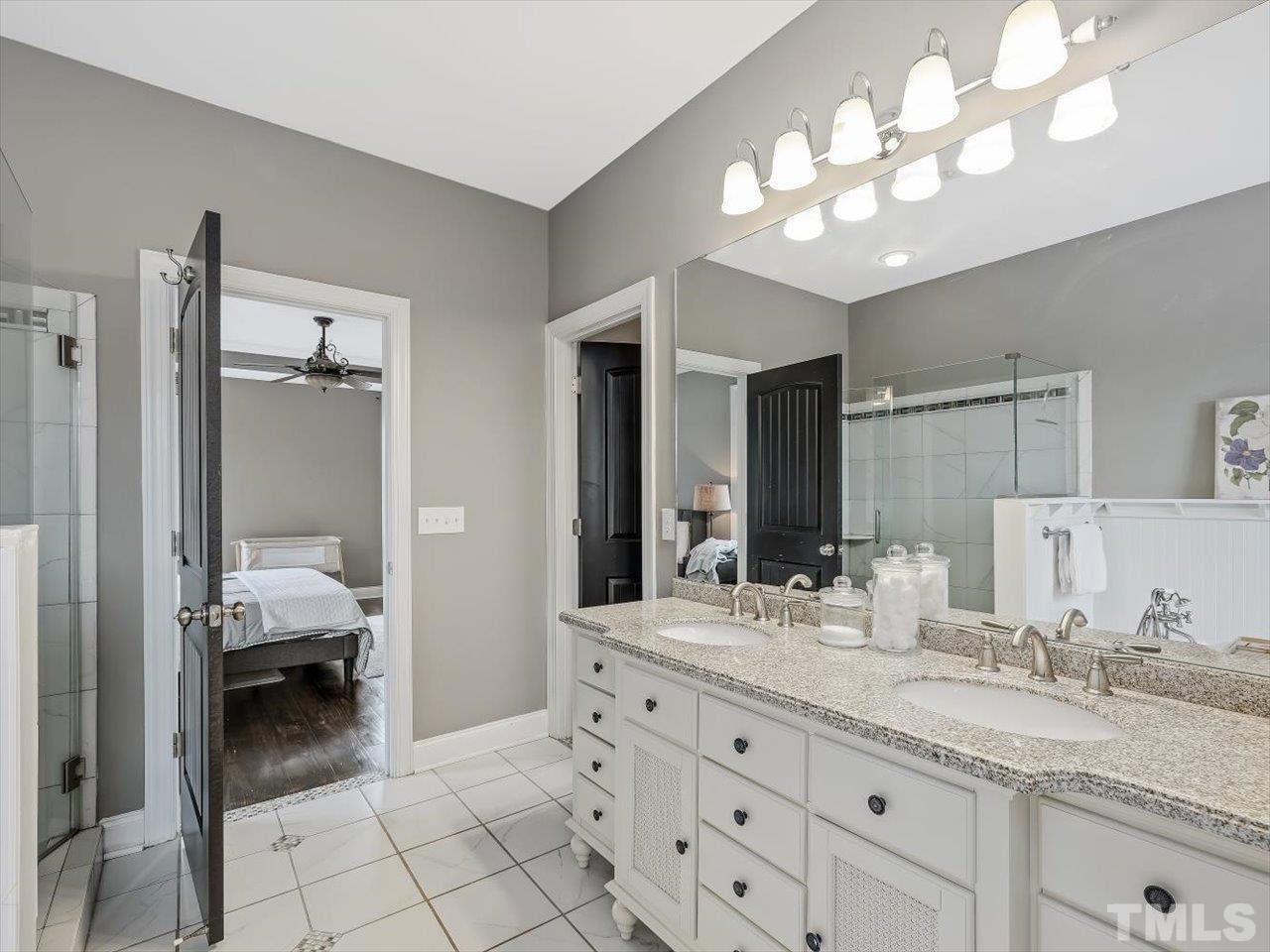 911 Wade Avenue Raleigh, NC 27605 - Photo 37 of 60 a en suite bathroom with double sink and a mirror