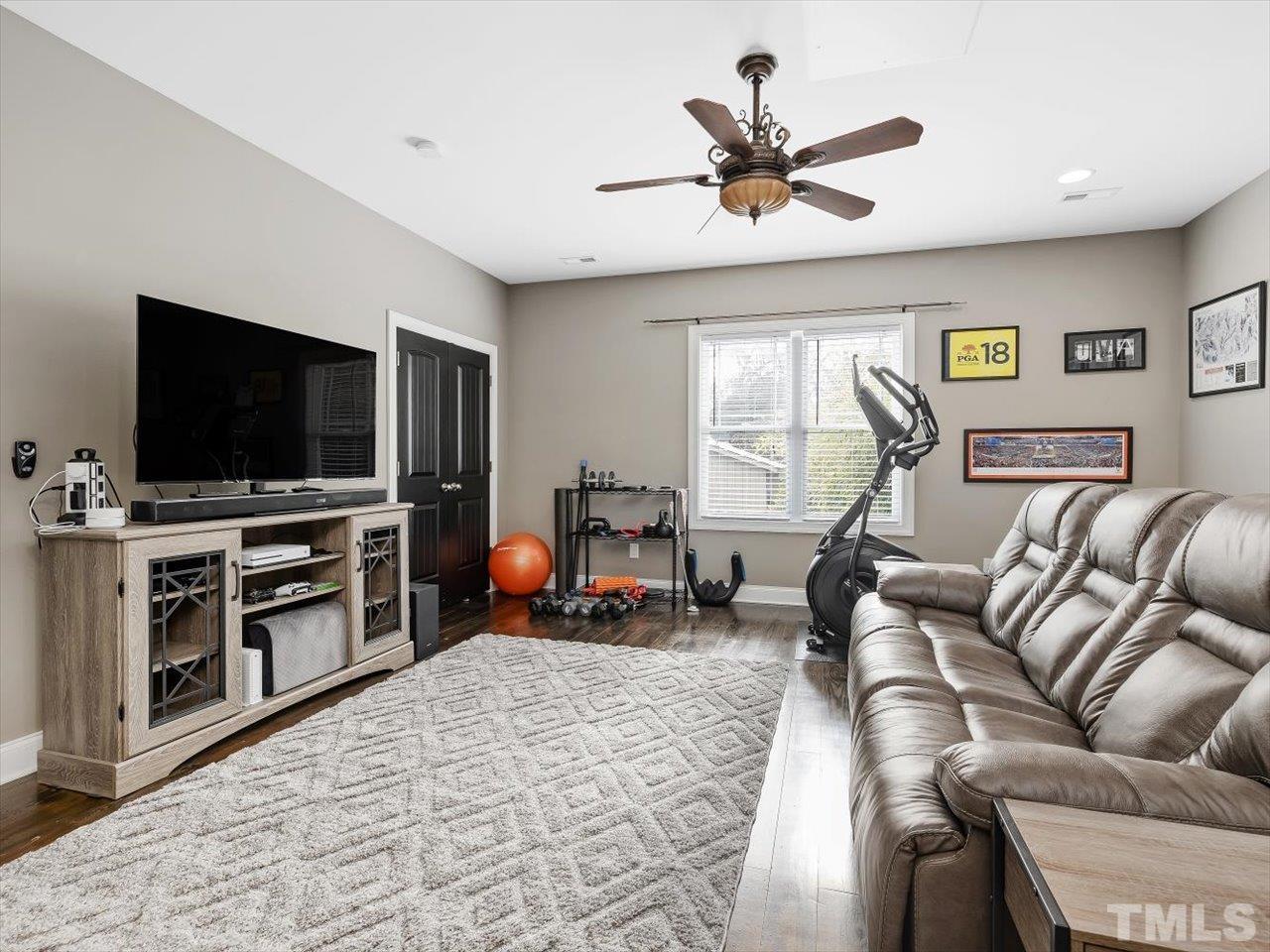 911 Wade Avenue Raleigh, NC 27605 - Photo 45 of 60 a living room with furniture and a flat screen tv