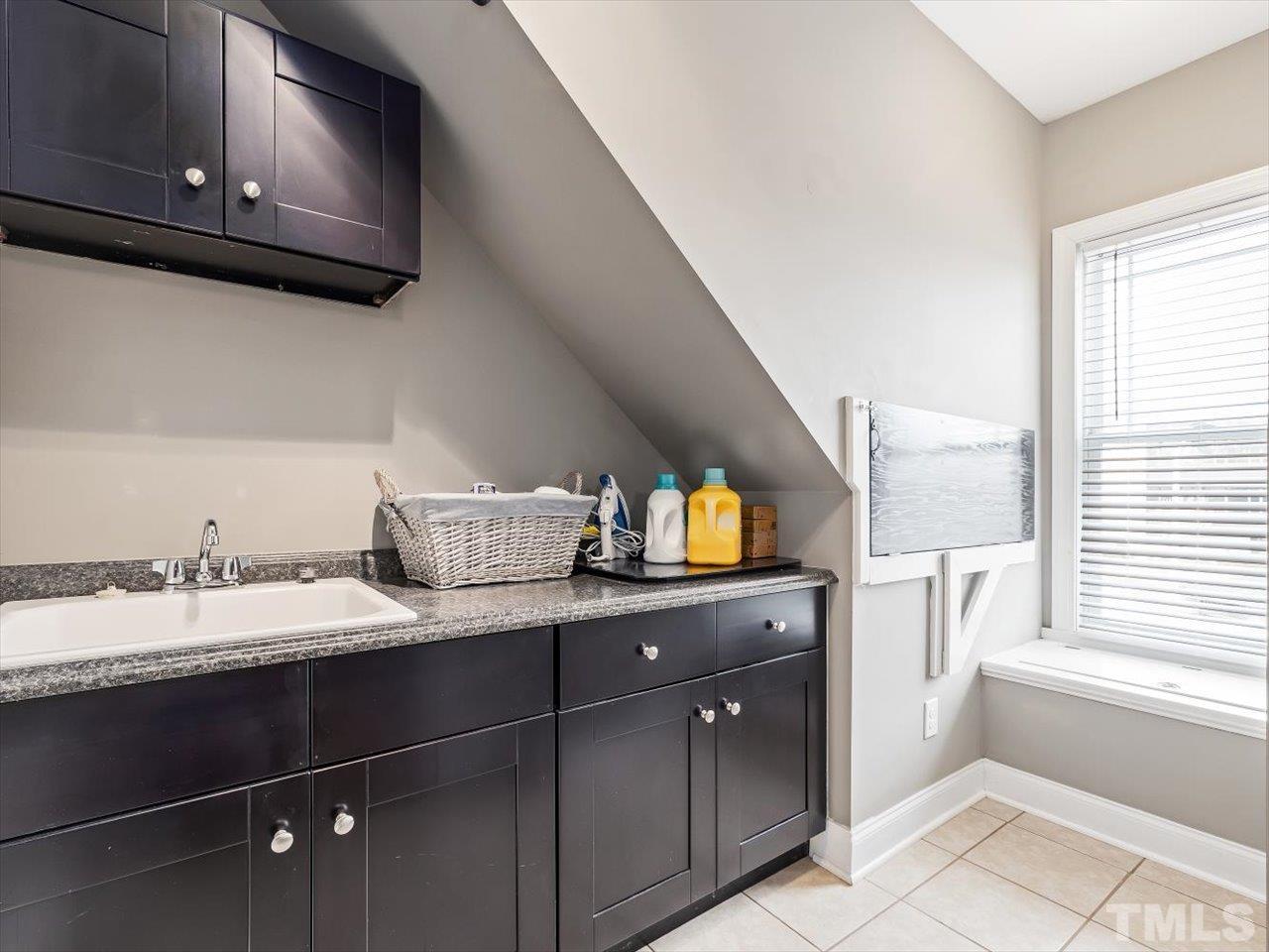 911 Wade Avenue Raleigh, NC 27605 - Photo 50 of 60 a kitchen with a sink and a cabinets