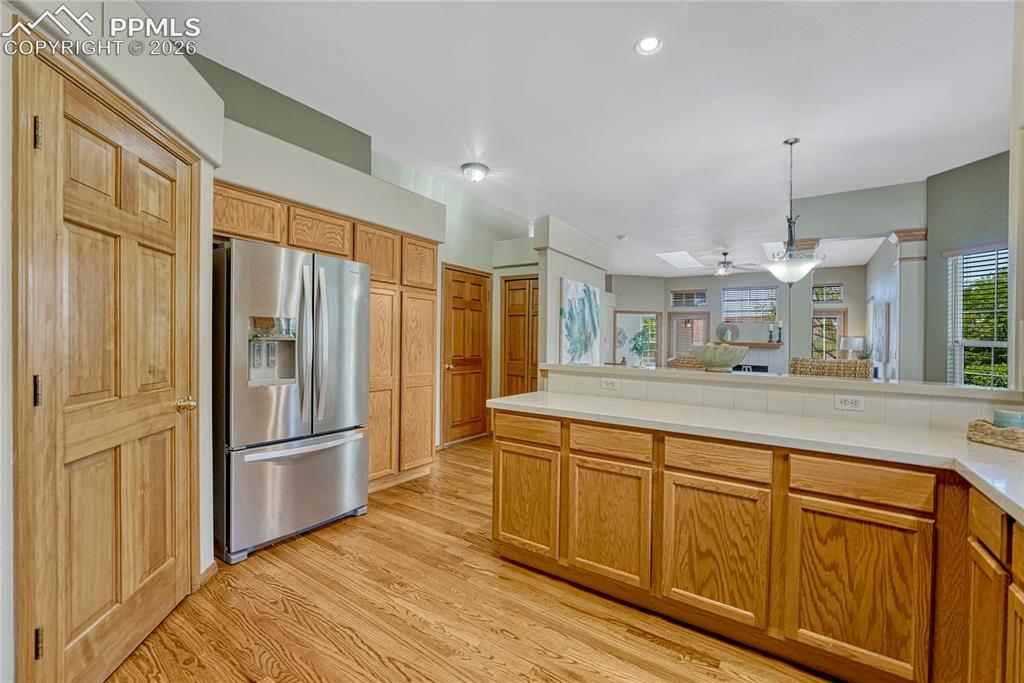 4601 Rowell Point Colorado Springs, CO 80923 - Photo 14 of 48 A large stainless-steel French door refrigerator brings a touch of modern luxury to this culinary space