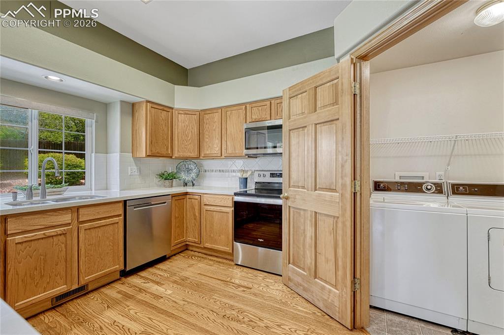 4601 Rowell Point Colorado Springs, CO 80923 - Photo 15 of 48 Tucked conveniently near the kitchen is a dedicated laundry space equipped with a washer and dryer