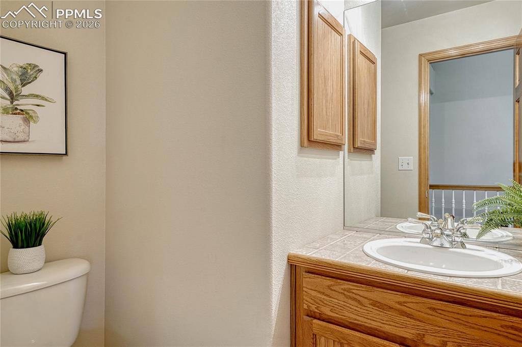 4601 Rowell Point Colorado Springs, CO 80923 - Photo 17 of 48 The main level includes a convenient half-bathroom with a charming tile vanity for your guests