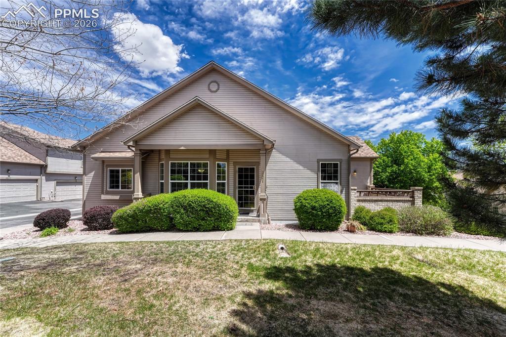 4601 Rowell Point Colorado Springs, CO 80923 - Photo 2 of 48 The covered entry creates an inviting first impression for guests. This home offers low-maintenance living with HOA-covered lawn care, exterior maintenance, and snow removal