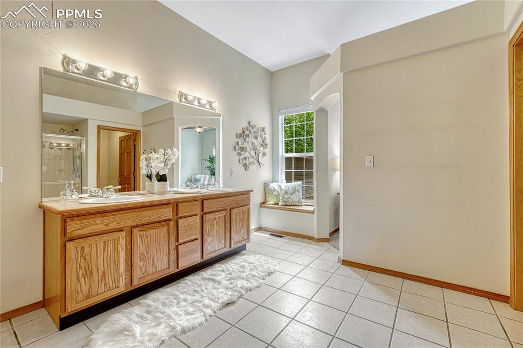4601 Rowell Point Colorado Springs, CO 80923 - Photo 23 of 48 A cozy built-in window bench adds a unique and charming touch to this spacious bathroom