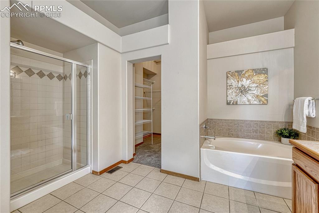 4601 Rowell Point Colorado Springs, CO 80923 - Photo 24 of 48 Unwind after a long day in the luxurious deep soaking tub, or utilize the separate free-standing shower