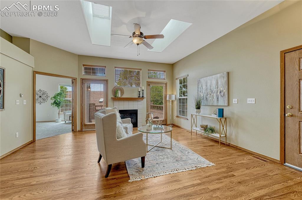 4601 Rowell Point Colorado Springs, CO 80923 - Photo 3 of 48 Step into a bright and airy living room full of natural light from two skylights and custom windows. The gorgeous hardwood flooring and gas fireplace make this a perfect space to relax