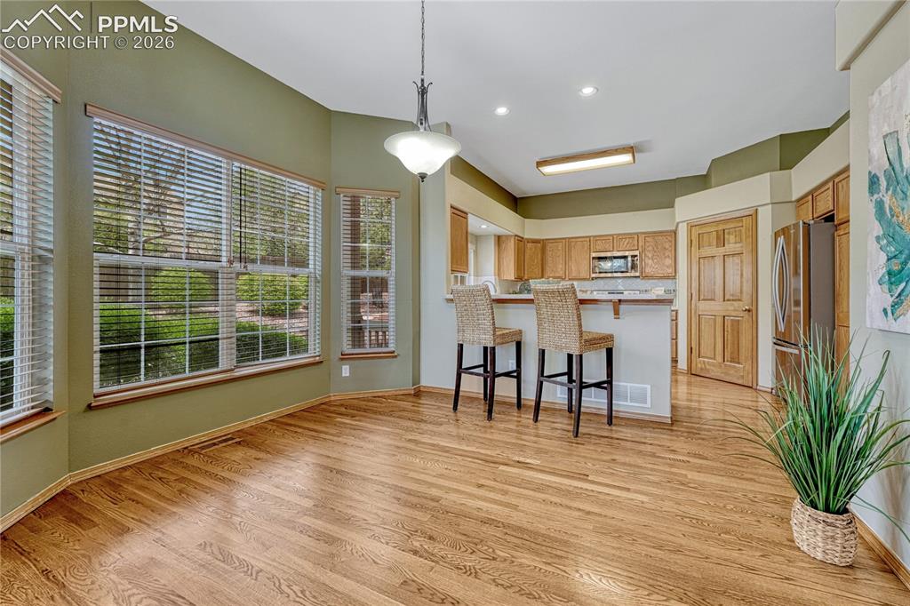 4601 Rowell Point Colorado Springs, CO 80923 - Photo 7 of 48 The dining area adjoining the kitchen offers a bright spot for morning coffee, framed by large custom windows