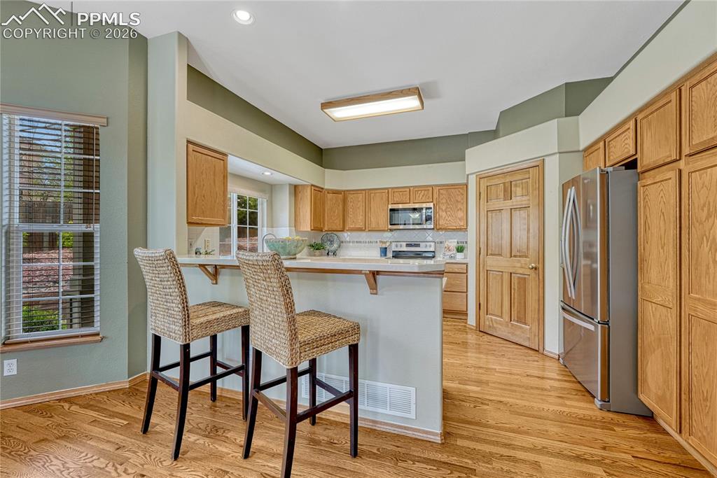 4601 Rowell Point Colorado Springs, CO 80923 - Photo 9 of 48 Pull up a stool to the convenient kitchen breakfast bar for casual dining or socializing