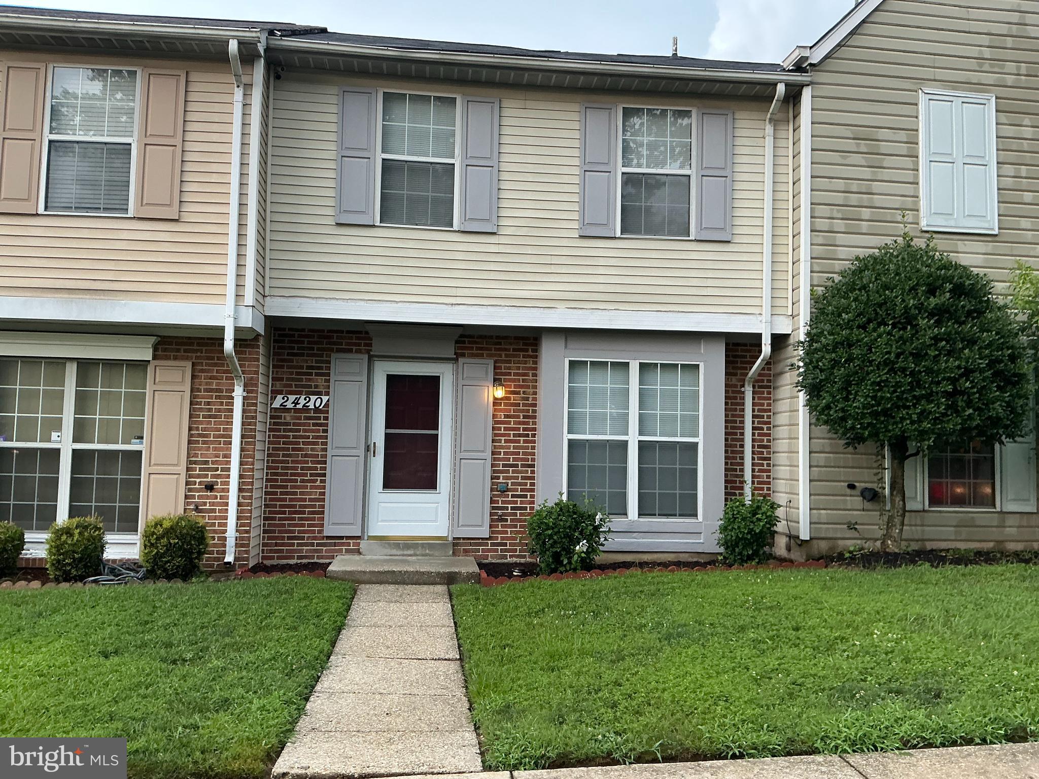 2420 Rosecroft Court Oxon Hill, MD 20745 - Photo 2 of 29 a front view of a house with a yard
