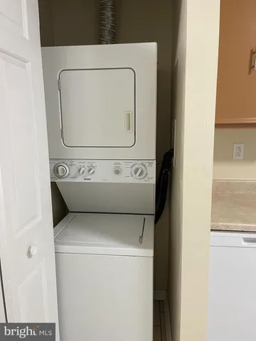 a utility room with cabinets washer and dryer