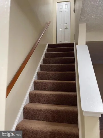 a view of a hallway with wooden shelves
