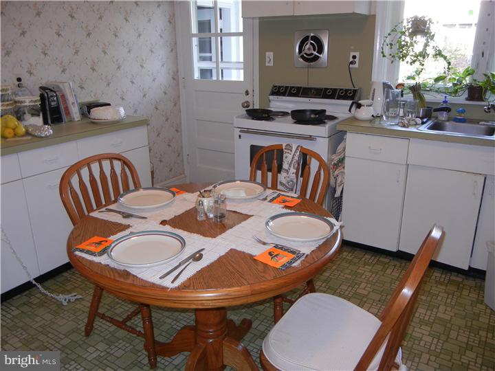 306 Smithfield Road Wallingford, PA 19086 - Photo 5 of 16 a table and chairs in a open kitchen