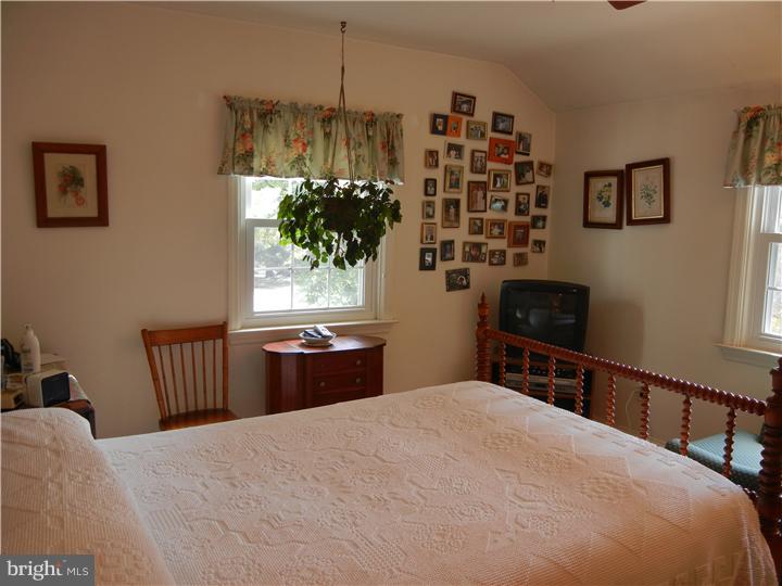 306 Smithfield Road Wallingford, PA 19086 - Photo 8 of 16 a bedroom with a bed dresser and a window