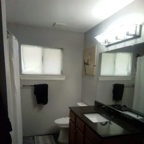 a living room with furniture and a pool table