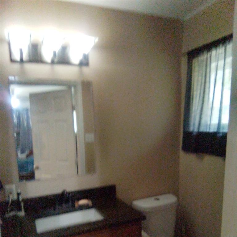 5786 Rockhill Road Fort Worth, TX 76112 - Photo 20 of 26 a bathroom with a sink toilet and mirror