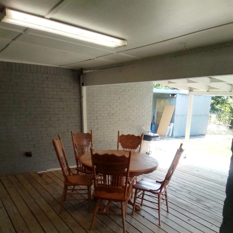 5786 Rockhill Road Fort Worth, TX 76112 - Photo 8 of 26 a view of a dining room with furniture and wooden floor