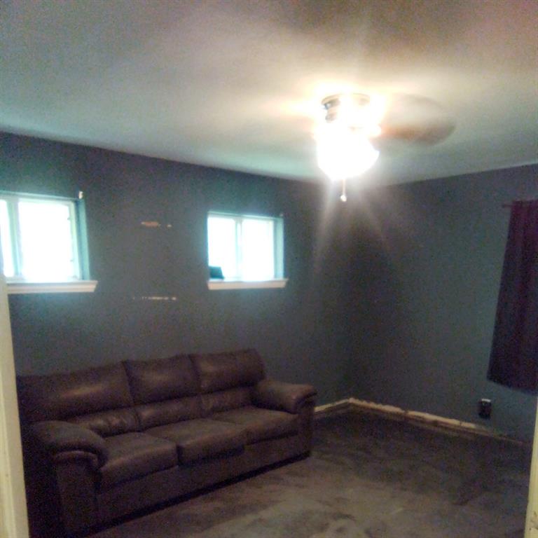 5786 Rockhill Road Fort Worth, TX 76112 - Photo 9 of 26 a living room with furniture and a lamp