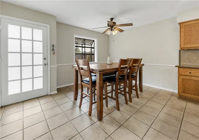 a view of a dining room with furniture and chandelier fan
